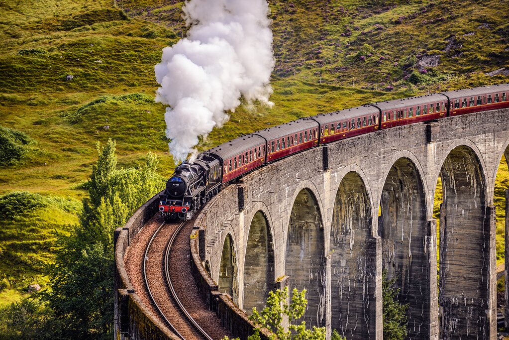 England Scotland tour Image of the Hogwarts Express, the iconic steam train from the Harry Potter series, traveling through the scenic countryside.